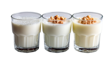 Three glasses of creamy beverages topped with crunchy nuts, set against a clean background
