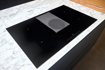 Induction cooker black glass hob with integrated hood or aspirating induction hob on marble light...