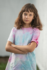 Portrait of young beautiful long-haired girl outdoors in summer.