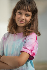 Portrait of young beautiful long-haired girl outdoors in summer.