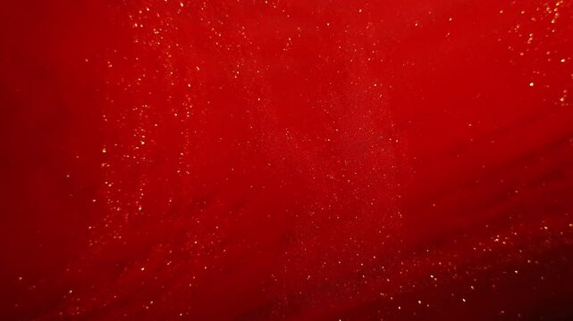 Futuristic red and golden waves of sparkling particles with shimmering dust, bokeh, and glowing light flares in abstract motion.