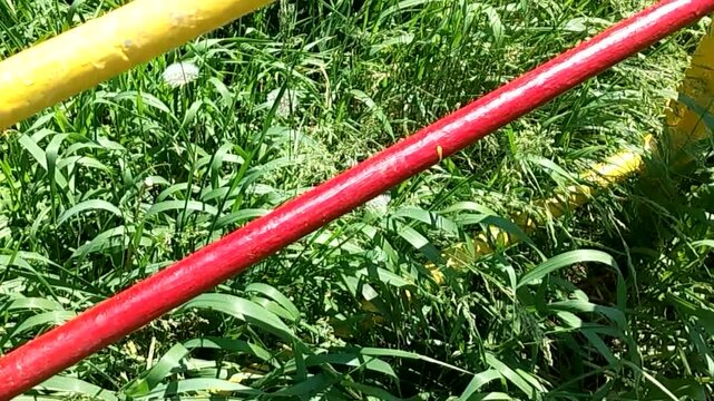 Colorful metal staircase on playground against green grass