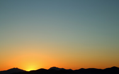 Sunset over mountains as black silhouette with blue and orange sky (Kos, Greece)
