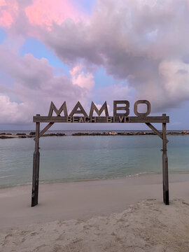 sign on the beach of mambo beach in curacao at dawn