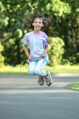 Portrait of young beautiful long-haired girl outdoors in summer.