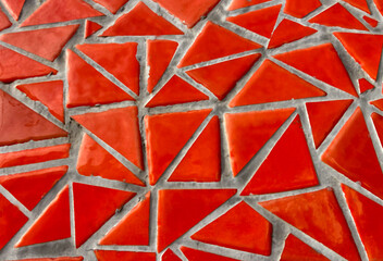 Broken tiles mosaic made with red ceramic pieces background texture for design.Colorful cracked...