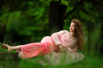 Portrait of beautiful young girl in park in spring