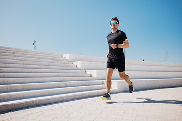 Running Swiftly on a Sunlit Pathway, a Man Embraces Fitness and Freedom in a Vibrant Urban Setting...
