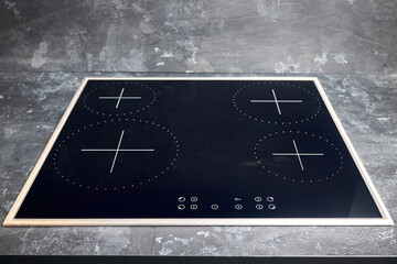 Flat cooktop cooking induction electric built black stove. Grey countertop with black glossy built...