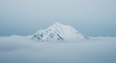Majestic SnowCapped Mountain Piercing the Misty Clouds