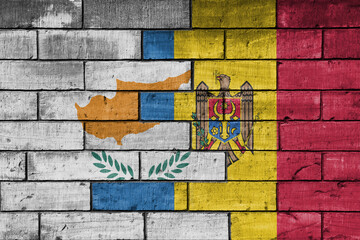 Fototapeta premium colourful painted big national flag of moldova and flag of cyprus on a massive old brick wall background. concept