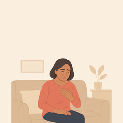 Sad woman feeling chest pain while sitting on sofa.