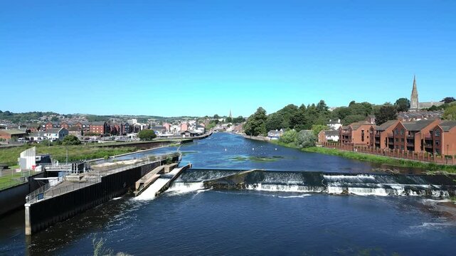 Exeter, Devon, England: DRONE VIEWS: Heading northwards over the River Exe and onwards to Exeter Quays and the city centre. Exeter is a popular UK travel destination (Clip 1 of 3).