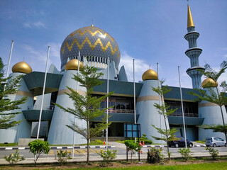 Kota Kinabalu: Sabah State Mosque. Cars on the road and blue sky with clouds. Borneo island. Malaysia. South-East Asia