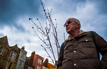 portrait of a senior man  against a storm sky in Oxford 