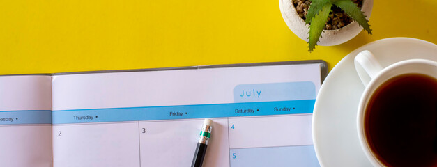 Calendar book for Planner to plan reminder daily appointment timetable, appointment, organization, and meeting agenda of job on wooden desk, work from home-banner image.