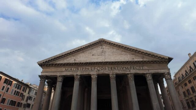 Pantheon facade with its inscription magrippalfcostertivmfecit meaning marcus agrippa, son of lucius, three times consul, made this slowly showing under blue cloudy sky in rome, italy