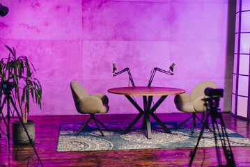 Podcast studio setup featuring microphone and headphones in a vibrant, modern environment