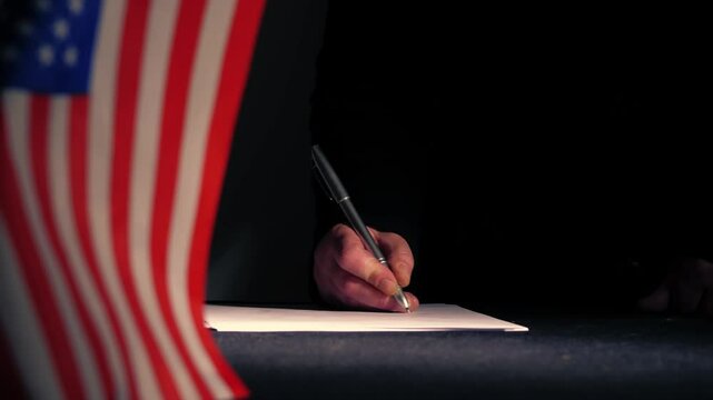Hand signing a trade deal with American USA flag 