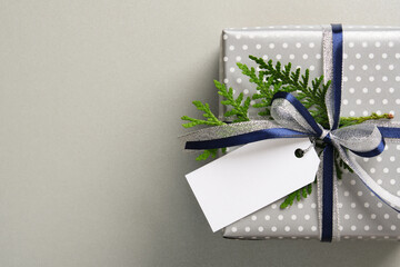 The gift boxes are wrapped in silver polka dot paper and decorated with dark blue and metallic...