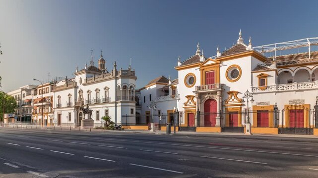 Plaza de Toros de la Real Maestranza de Caballeria de Sevilla timelapse hyperlapse. Traffic passing in front of its facade. Historic bullring in Seville, Spain, known for its bullfighting festivals.