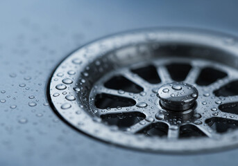 Obraz premium Sparkling Metal Sink Drain with Water Droplets