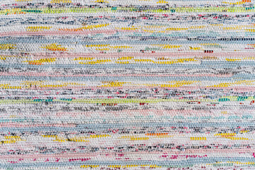 Traditional colourful wool mat texture with striped pattern