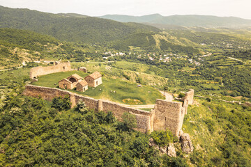 Aerial top view Manavi Fortress Complex. A Medieval Royal Stronghold. Strategic Hilltop Citadel Overlooking Iori Valley in Kakheti, Georgia. Hidden gem sightseeing off the beaten path attraction