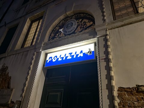 Polizia sign abone the entrace to police office in Venice, Italy at night