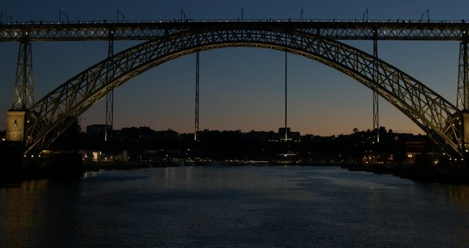 Night Boat Arrival Under Dom Lu&iacute;s I Bridge in Porto, Portugal.Cinematic 4K night footage filmed from a boat approaching the iconic Dom Lu&iacute;s I Bridge in Porto, Portugal. GPS: 41.1400&deg; N, 8.6111&deg; W