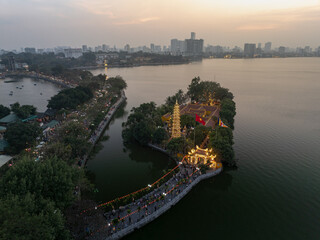 Visit to Tran Quoc Temple at sunset in Hanoi, Vietnam, showcasing serene architecture and vibrant nature