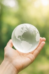 Hand holding translucent globe over green background symbolizing environmental care. AI-generated.