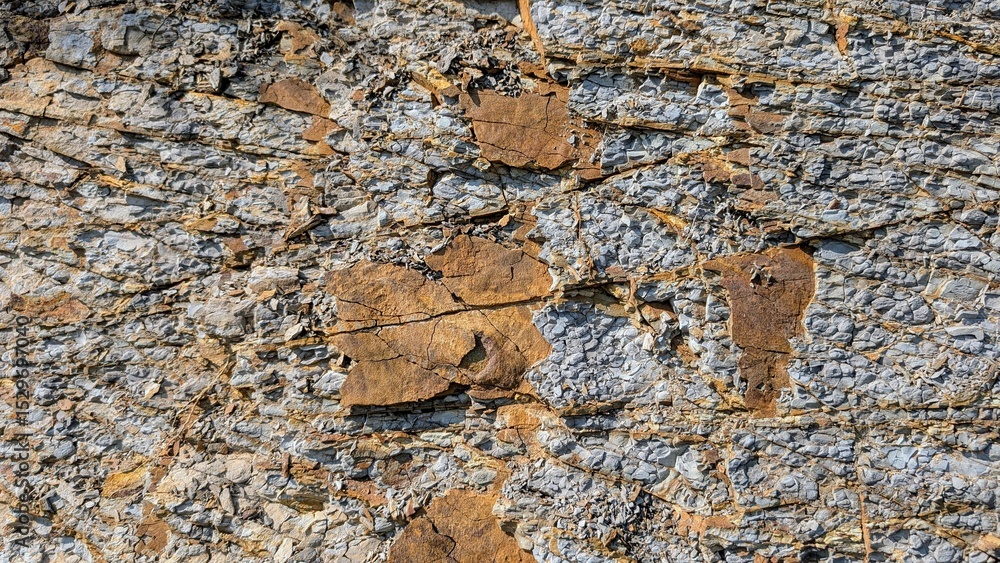 Poster weathered rock surface displaying intricate sedimentary layers, revealing complex geological pattern