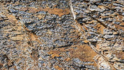 Sedimentary rock layers intersecting, forming vibrant geological patterns revealing earth's complex...