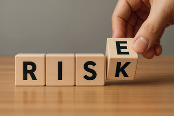 Naklejka premium Risk and Opportunity Concept – Hand Flipping Wooden Block to Change Word Risk into Rise