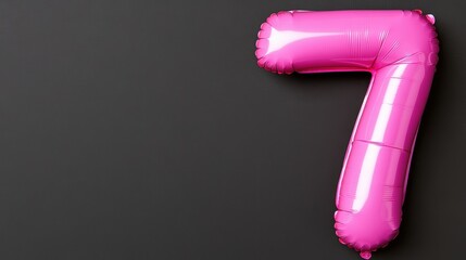 A vibrant pink foil balloon shaped like the number seven against a dark background, perfect for birthday celebrations or themed parties