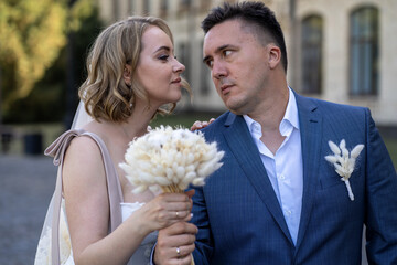 portrait of bride and groom in the park. Wedding day. Bride and groom in love. Happy young couple...