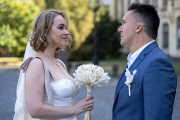 portrait of bride and groom in the park. Wedding day. Bride and groom in love. Happy young couple...