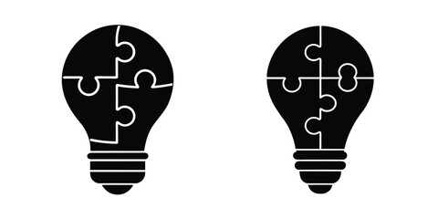Light Bulb Silhouette with a Jigsaw Puzzle Piece Forming Inside Isolated on White Background