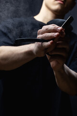 Barber is holding a brush for powder hairdresser and razor blade