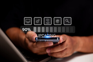 A person holds a smartphone while a digital progress bar shows 90% with the word "Updating" overlayed on a dark background.