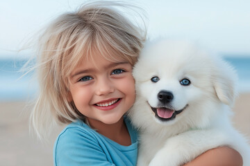 Girl with blonde hair in blue T-shirt hugging dog Samoyed on the beach