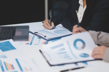 Close up of Business team analyzing income charts and graphs with modern laptop computer. Business analysis and strategy concept.