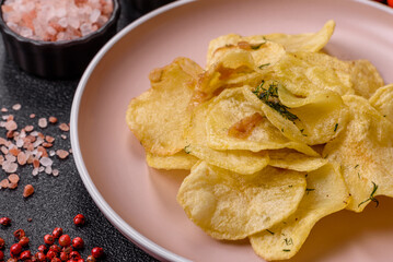 Crisps fried with salt, spices and garlic. Cooked potatoes