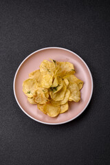 Crisps fried with salt, spices and garlic. Cooked potatoes