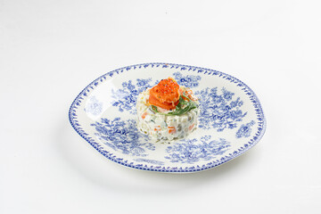 Portion of gourmet olivier salad with salmon on white background
