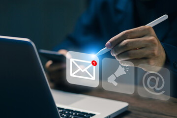 Businessman checking email notification on digital screen using stylus. Concept of email marketing, communication, online messaging, and digital technology.