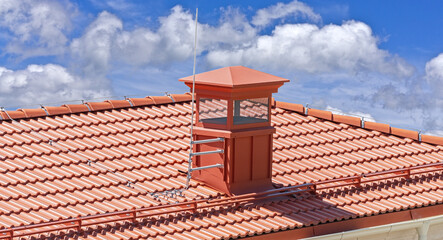 house with a roof from a red shingles with a pipe