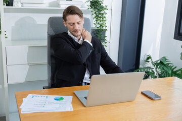 Caucasian businessman with neck and shoulder pain suffer from office syndrome