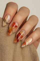 Abstract nail art in autumn tones: Hand with pointed nails and geometric design in warm and neutral colors, perfect for expressing creativity and style. Ideal for beauty themes, manicure trends and ar